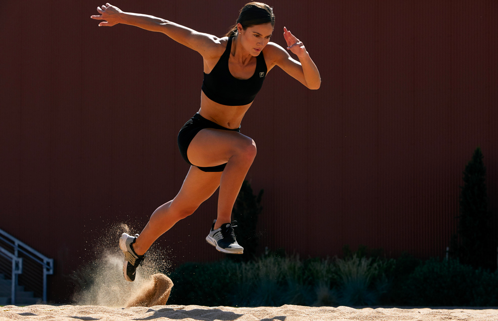 woman works out in sandy area