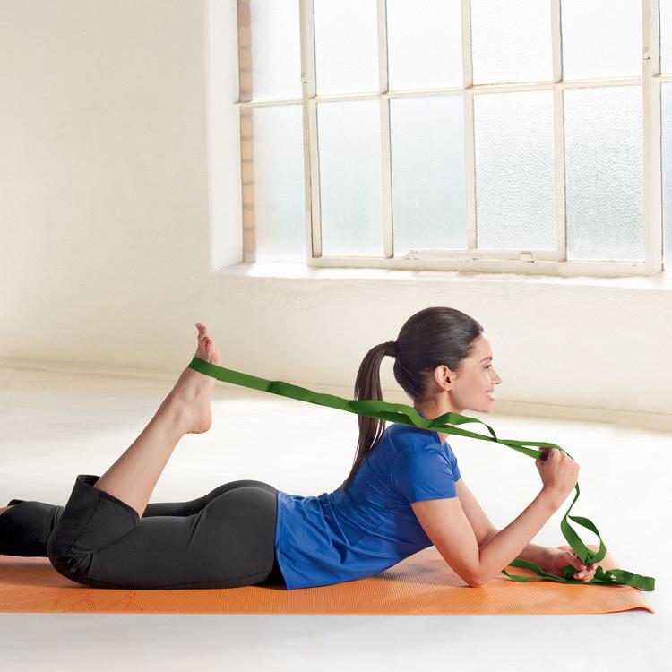 woman stretching hamstring with Gaiam Restore Multi-Grip Stretch Strap